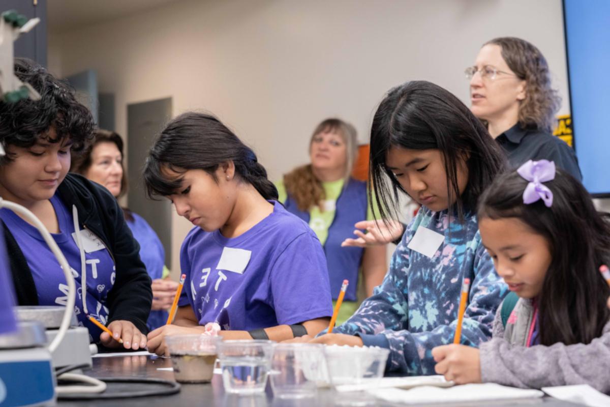 girls work on an activity during the expanding your horizons event